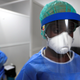A healthcare worker wearing protective gear stands next to a testing booth for the coronavirus disease at an Institute for Health Research, Epidemiological Surveillance and Training (IRESSEF) testing center, in Dakar.